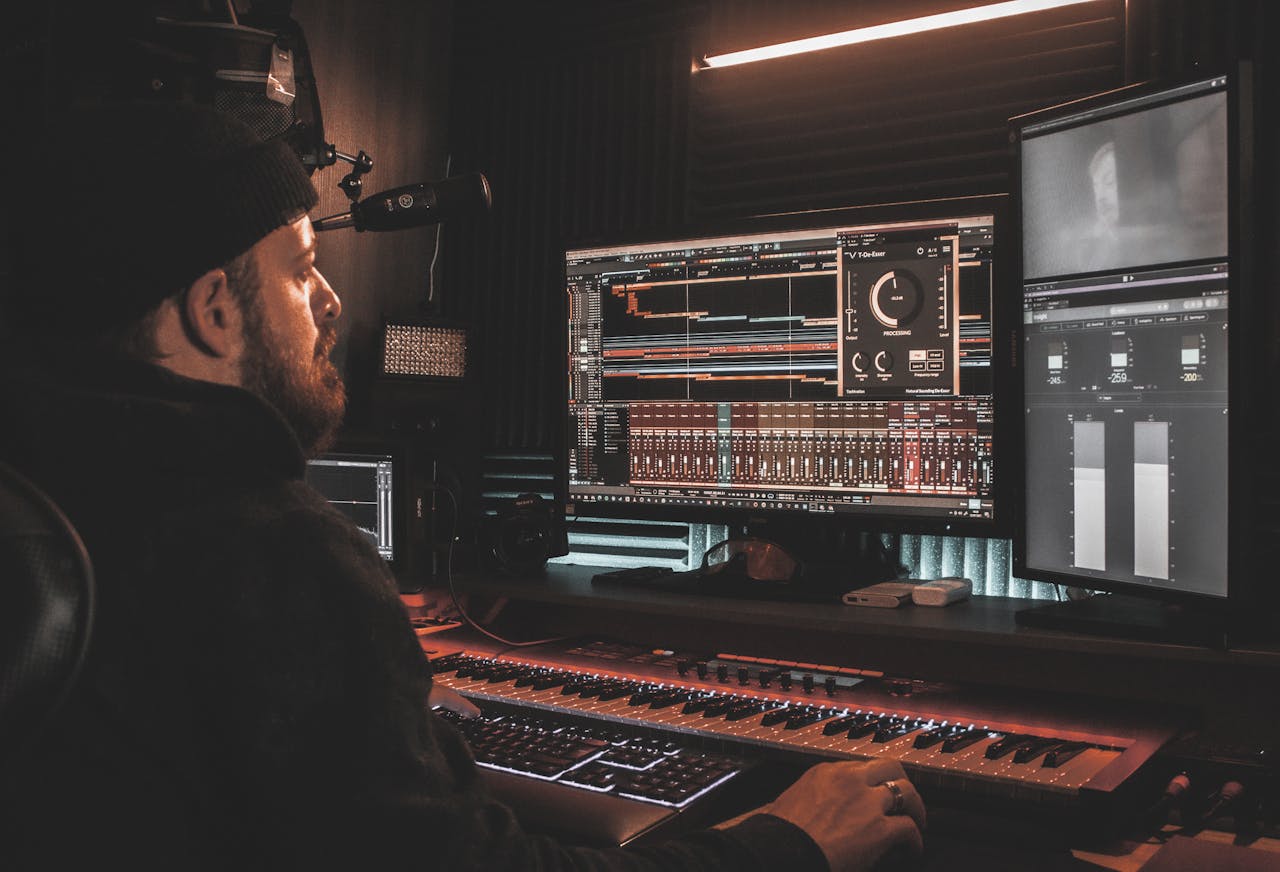 about-us A professional audio engineer working at a digital music production setup in a home studio.
