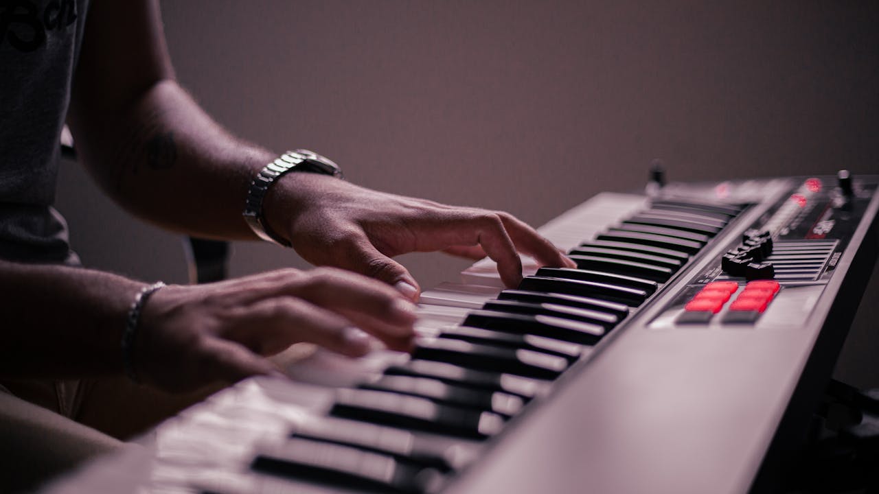 A musician's hands expertly playing an electronic keyboard, capturing the passion for music.